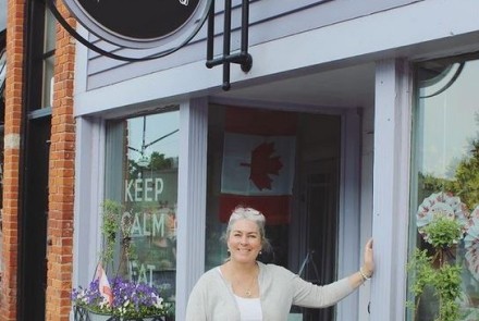 Casey Thomson Owner of Cheese Gallery in front of Shop