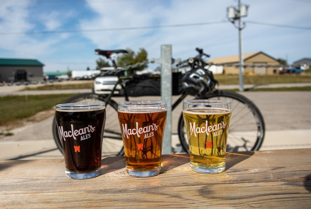 Three sample-sized beers on an outdoor table.