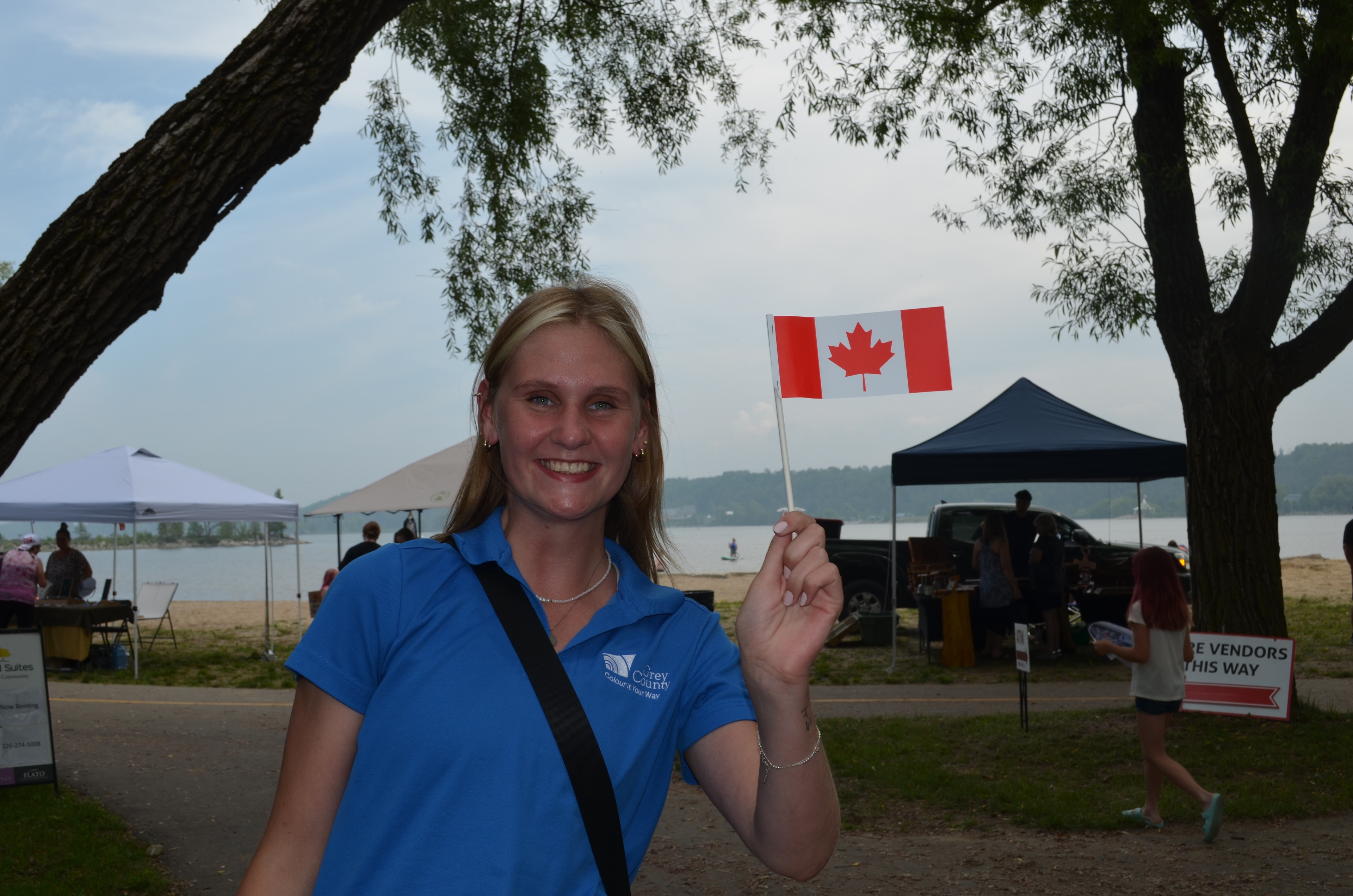 Girl smiling with mini canadian flag