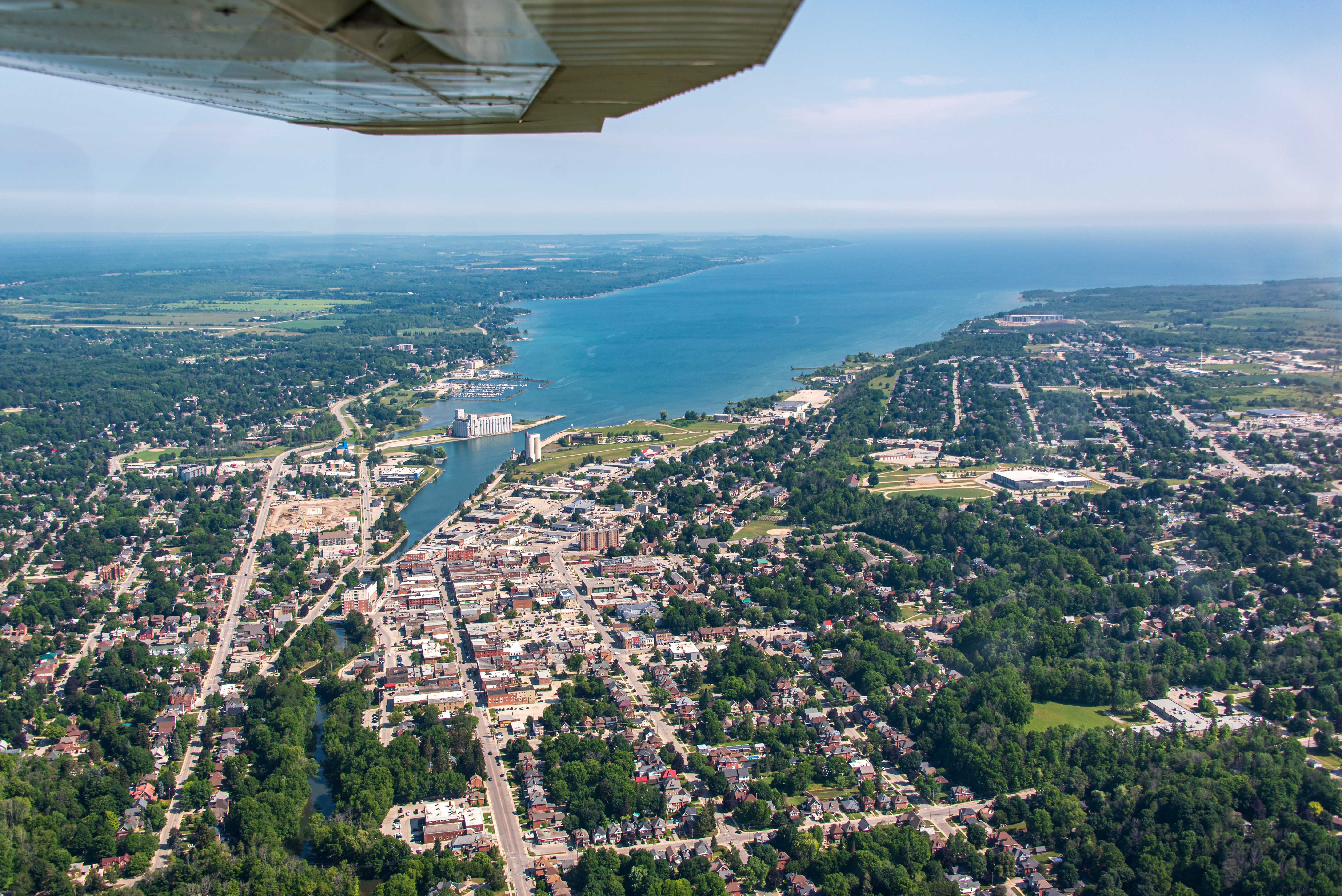 Aerial view of a city on a bay. A harbour bisects the city.