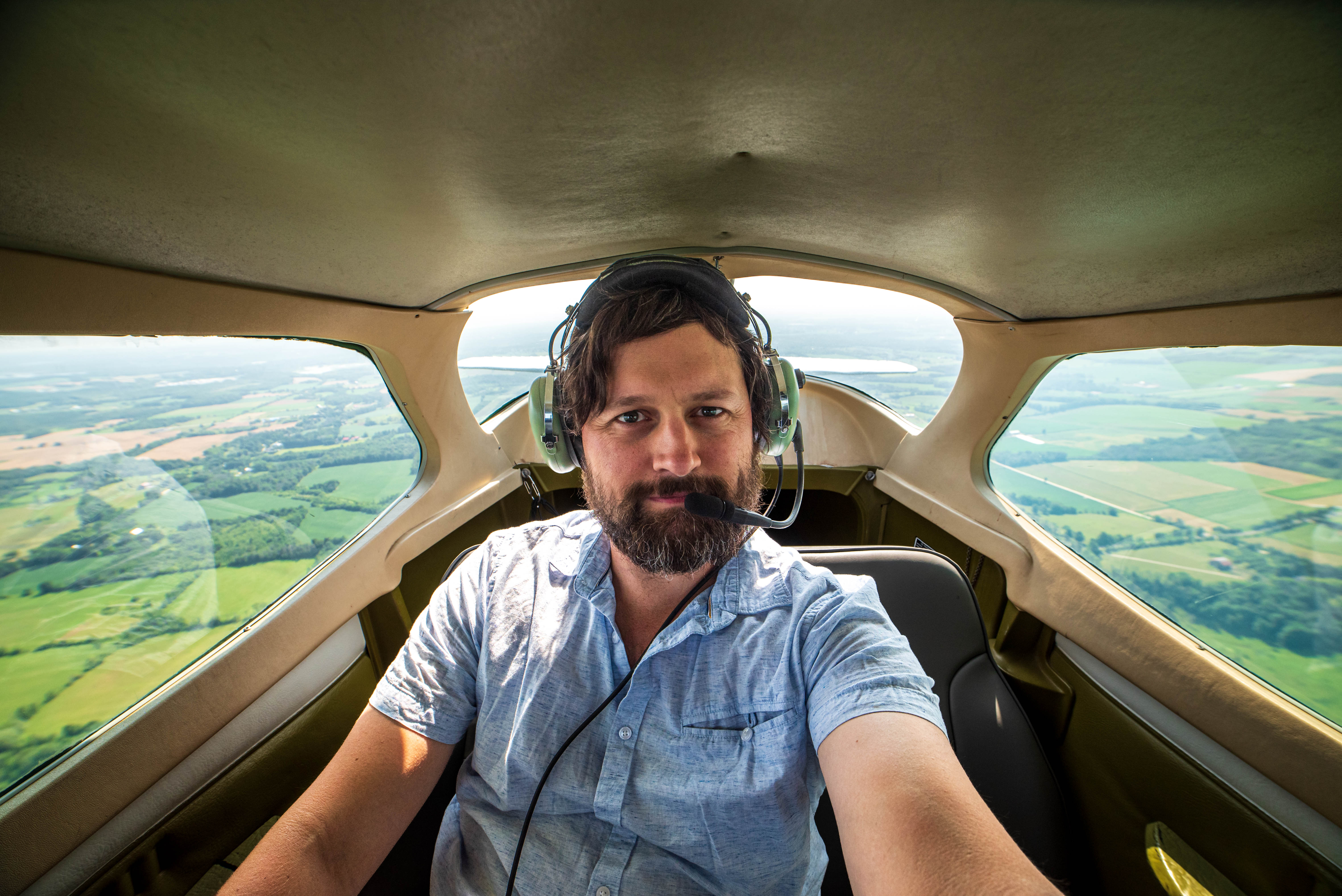 Selfie style photo of a passenger in a small aircraft.