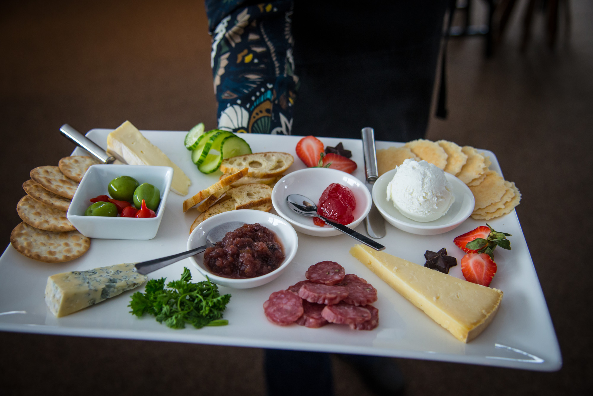 A charcuterie plate with cheese, meats, fruits etc.