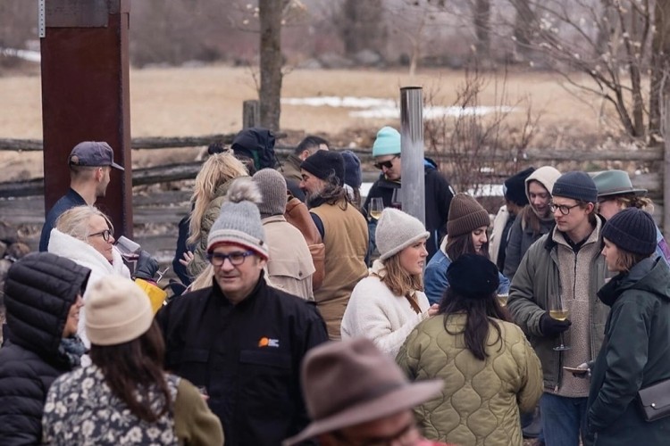 A group of people attend an outdoor event.