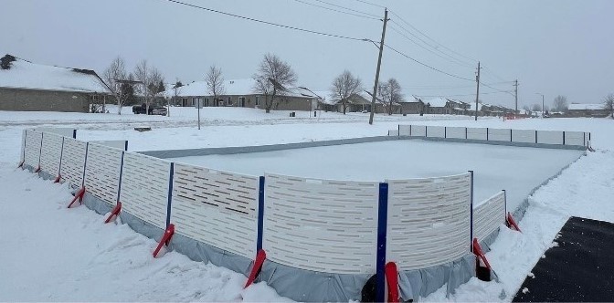 Outdoor hockey rink with boards.