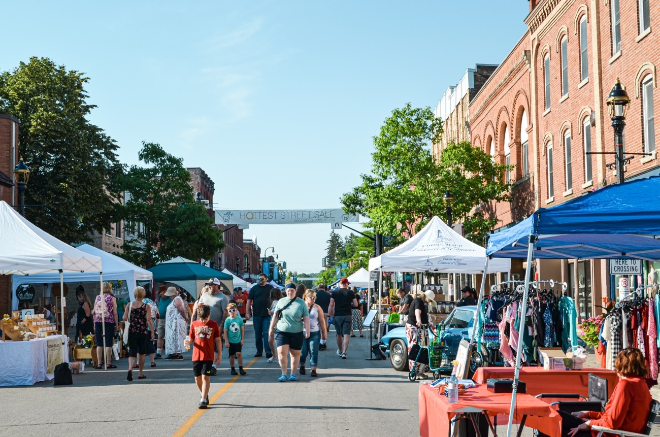 a crowd of people at a downtown market event
