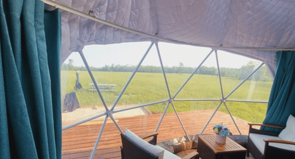 Interior view looking out the windows of a geodesic dome tent.