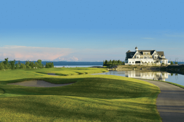 A golf course with large clubhouse.