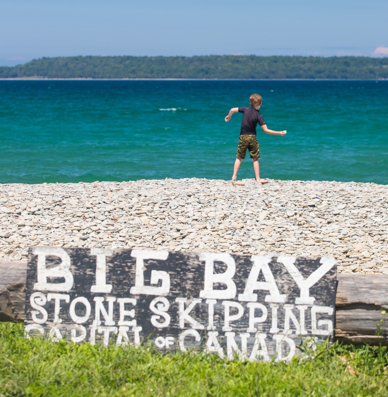 A child skips stones.