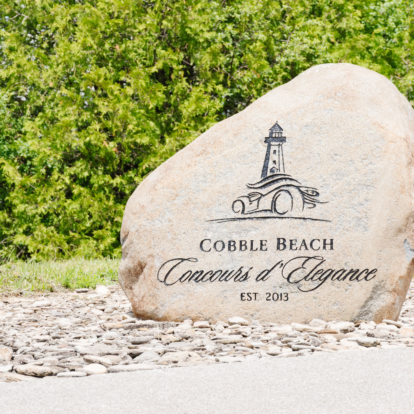A large stone engraved with a lighthouse emblem.