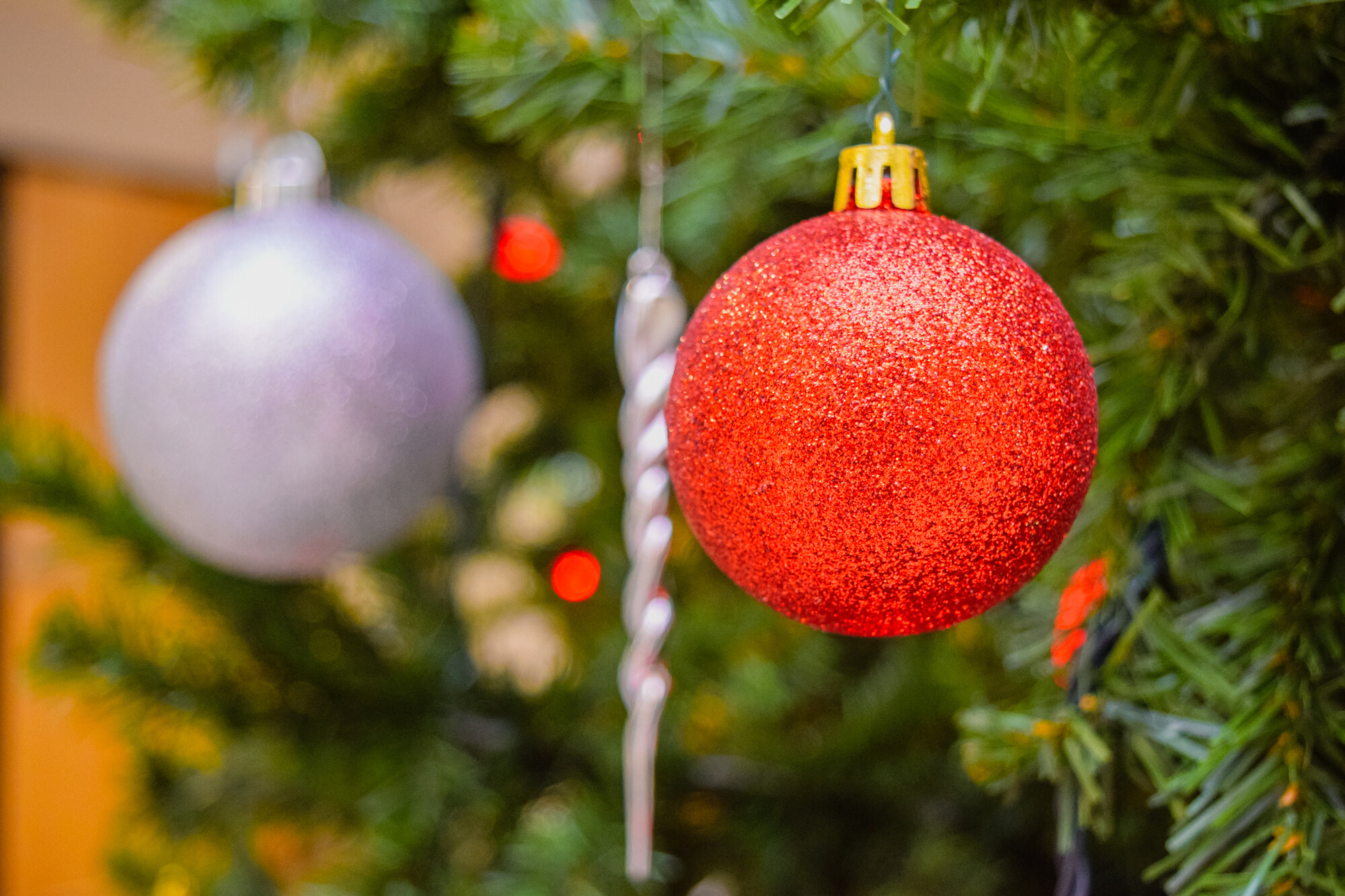 Christmas decorations hang on a tree.