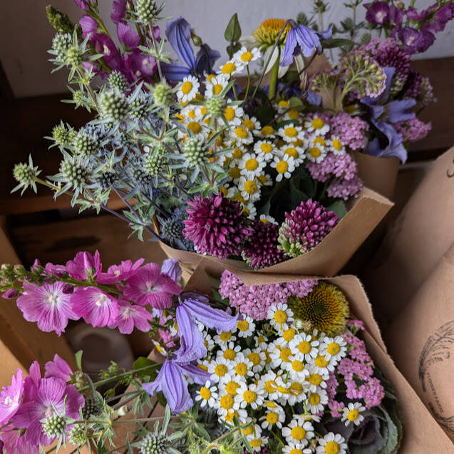 Image shows two bouquets of colorful flowers