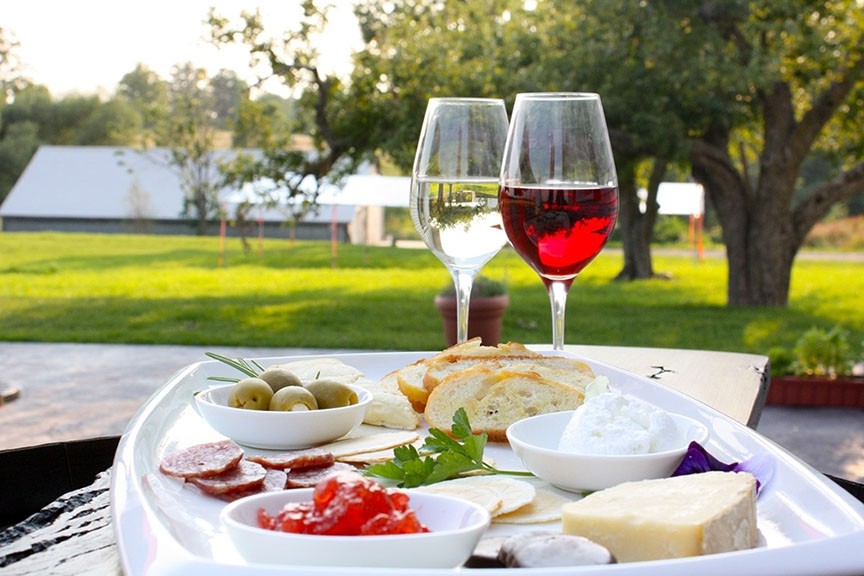 Charcuterie plate and two glasses of wine.