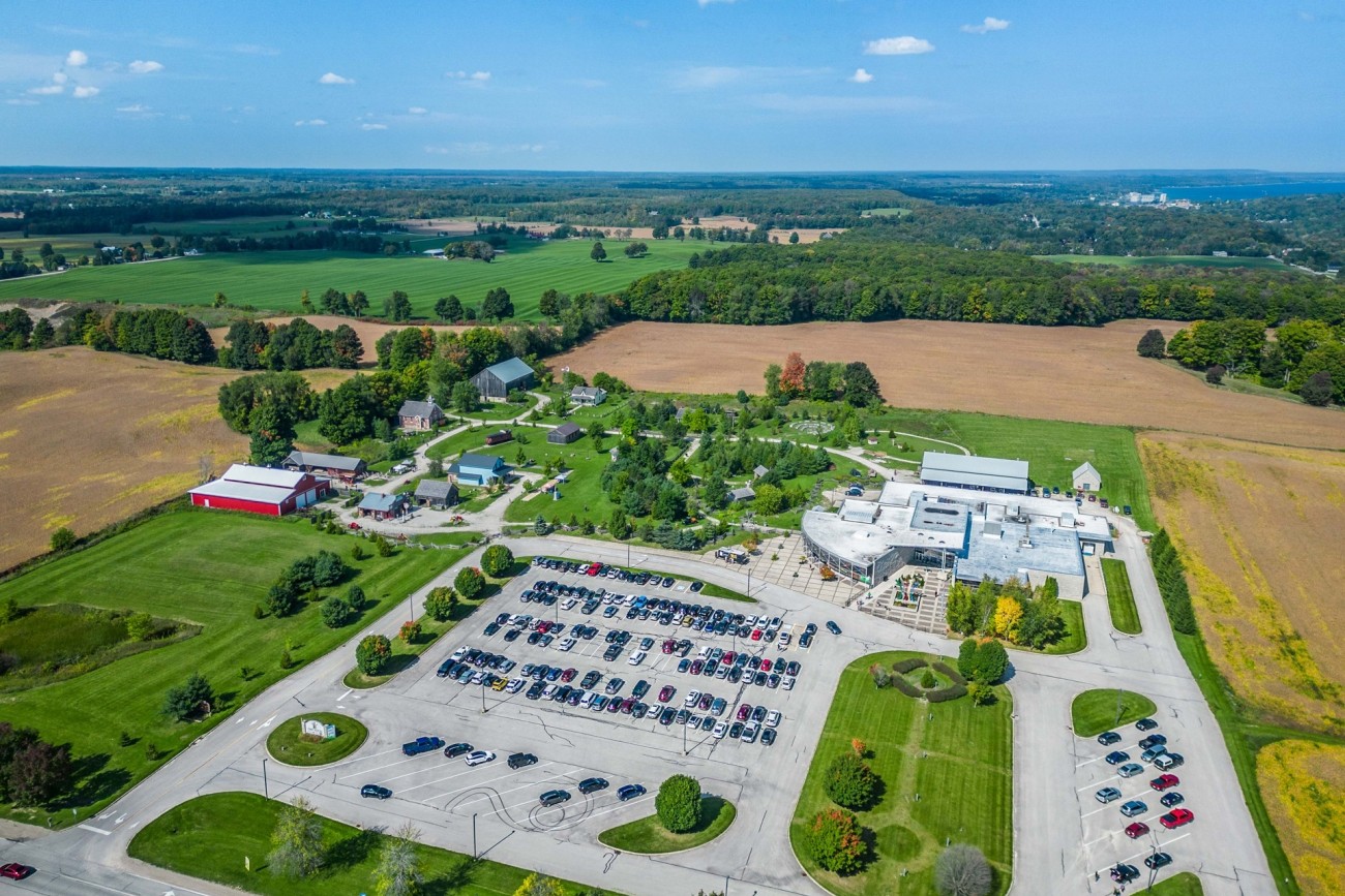 Aerial view of a museum and historic village in a rural setting.