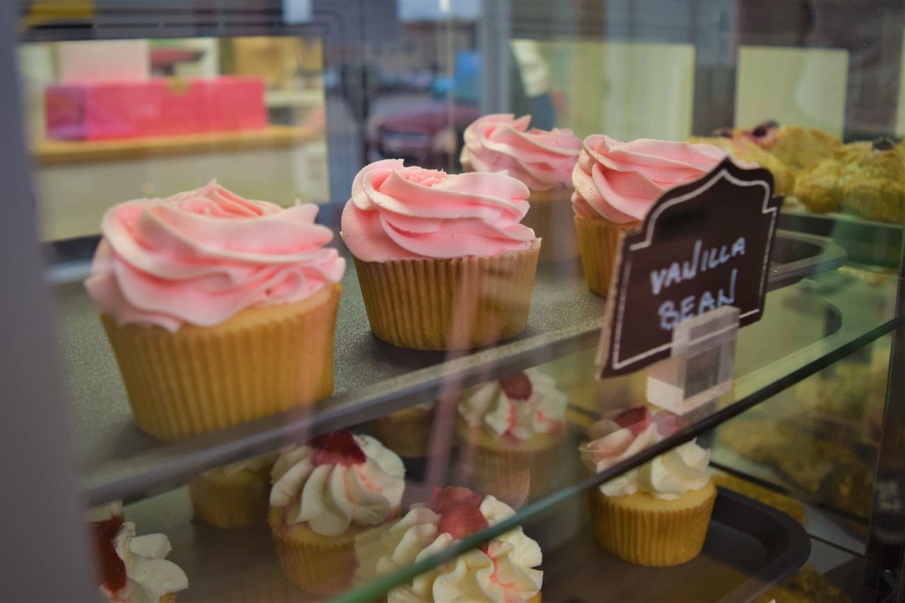 Glass display of cupcakes.